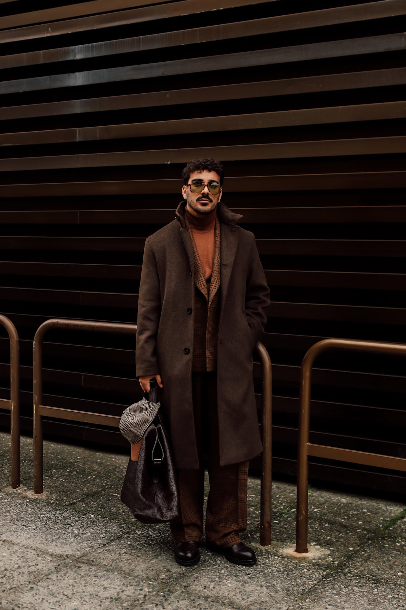 A man wearing a dark brown single-breasted wool trench 