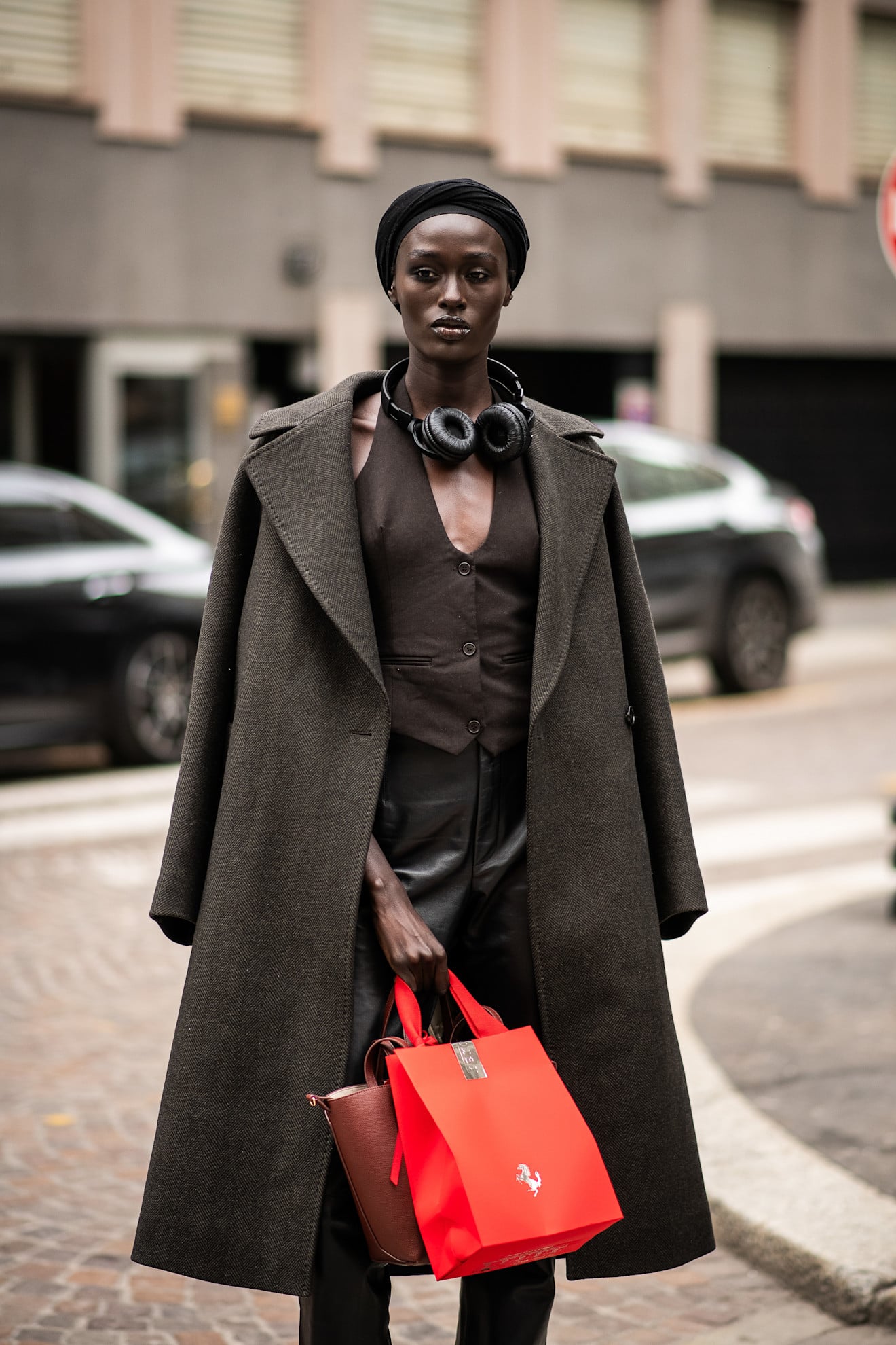 A woman with a classic dark brown wool trench coat with oversized lapels